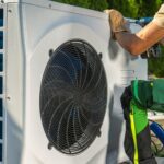 HVAC Worker Installing Electric Heat Pump